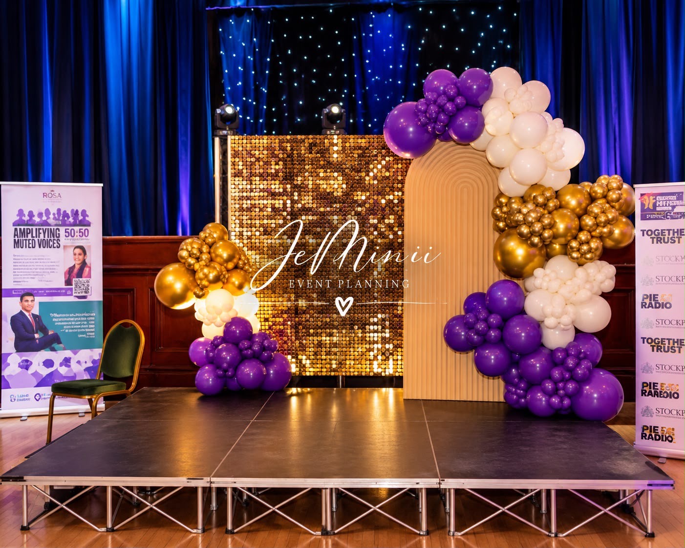 Awards stage with gold shimmer wall, fluted panel and purple balloon garland, styled by Jeminii Event Styling in Manchester