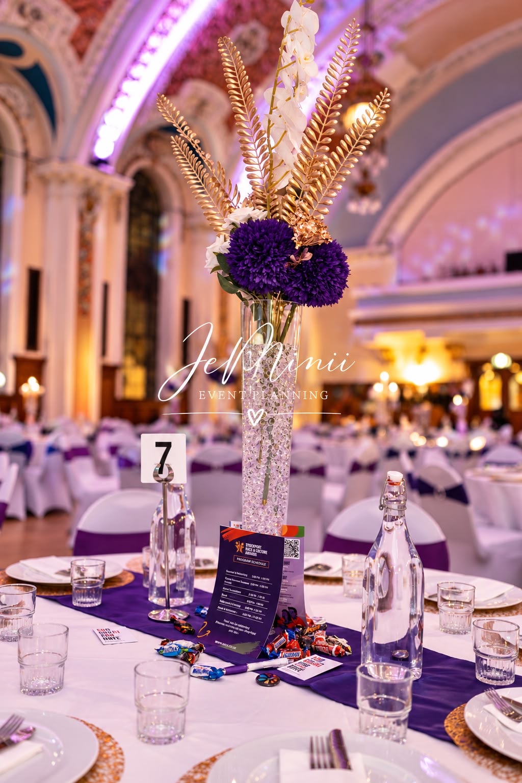 Glass cylinder centrepiece with pom-pom flowers and gold placemats, styled by Jeminii Event Styling in Manchester
