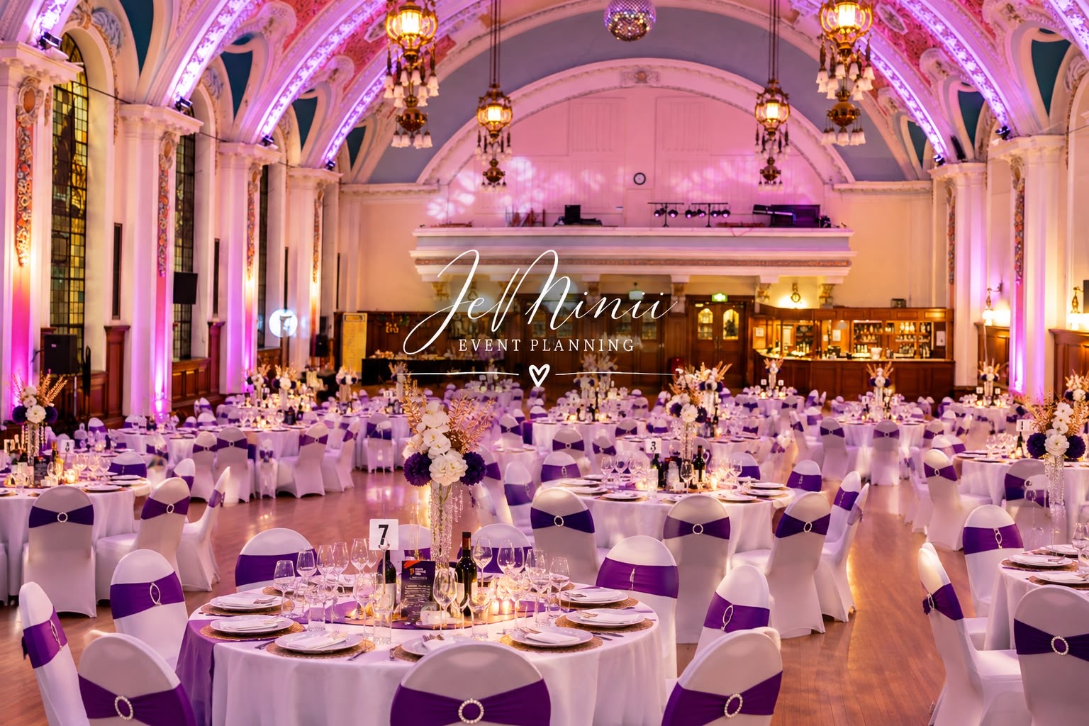 Grand ballroom reception with purple runners, orchid centrepieces and magenta uplighting, styled by Jeminii Event Styling in Manchester