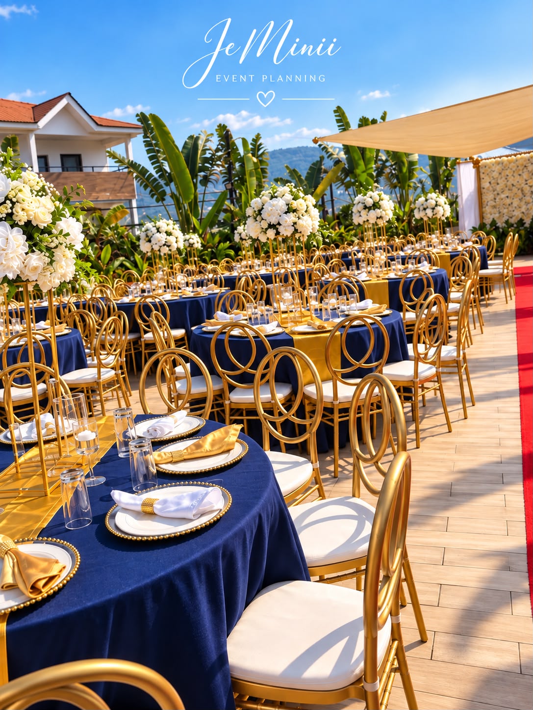 Luxury outdoor wedding reception with navy linen, gold chairs and a red aisle, styled by Jeminii Event Styling in Freetown, Sierra Leone